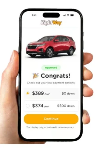 Hand holding a smartphone displaying the RightWay app, showing car loan approval with payment options for a red SUV.